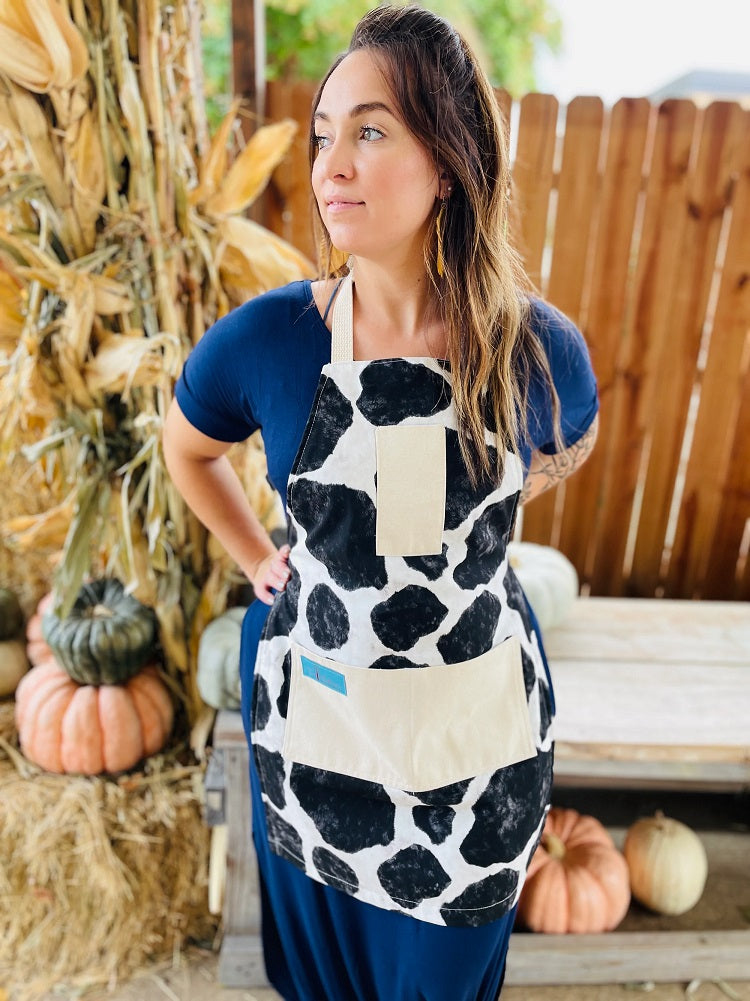 Susanna Cow Print Apron being worn