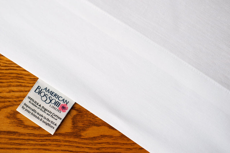 Organic cotton pillowcases in white color showing American Blossom Label.