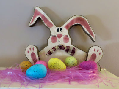Wooden Easter Bunnies can sit on your mantle. Decorate them with your Easter basket eggs and grasses